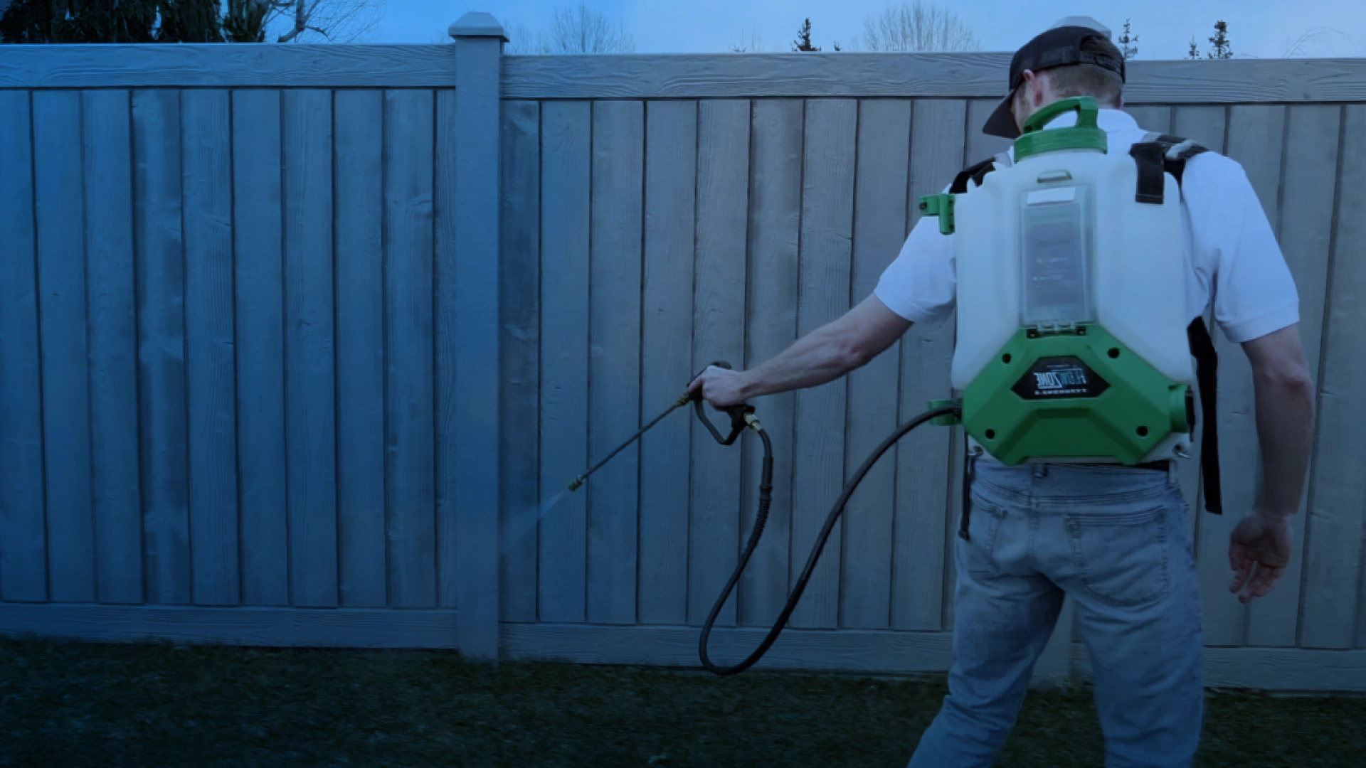 a contractor fumigating a backyard